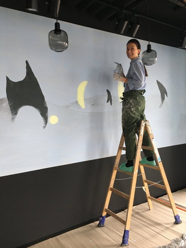 Magdalena Karpińska while creating a mural at the ING headquarters at Plac Unii
